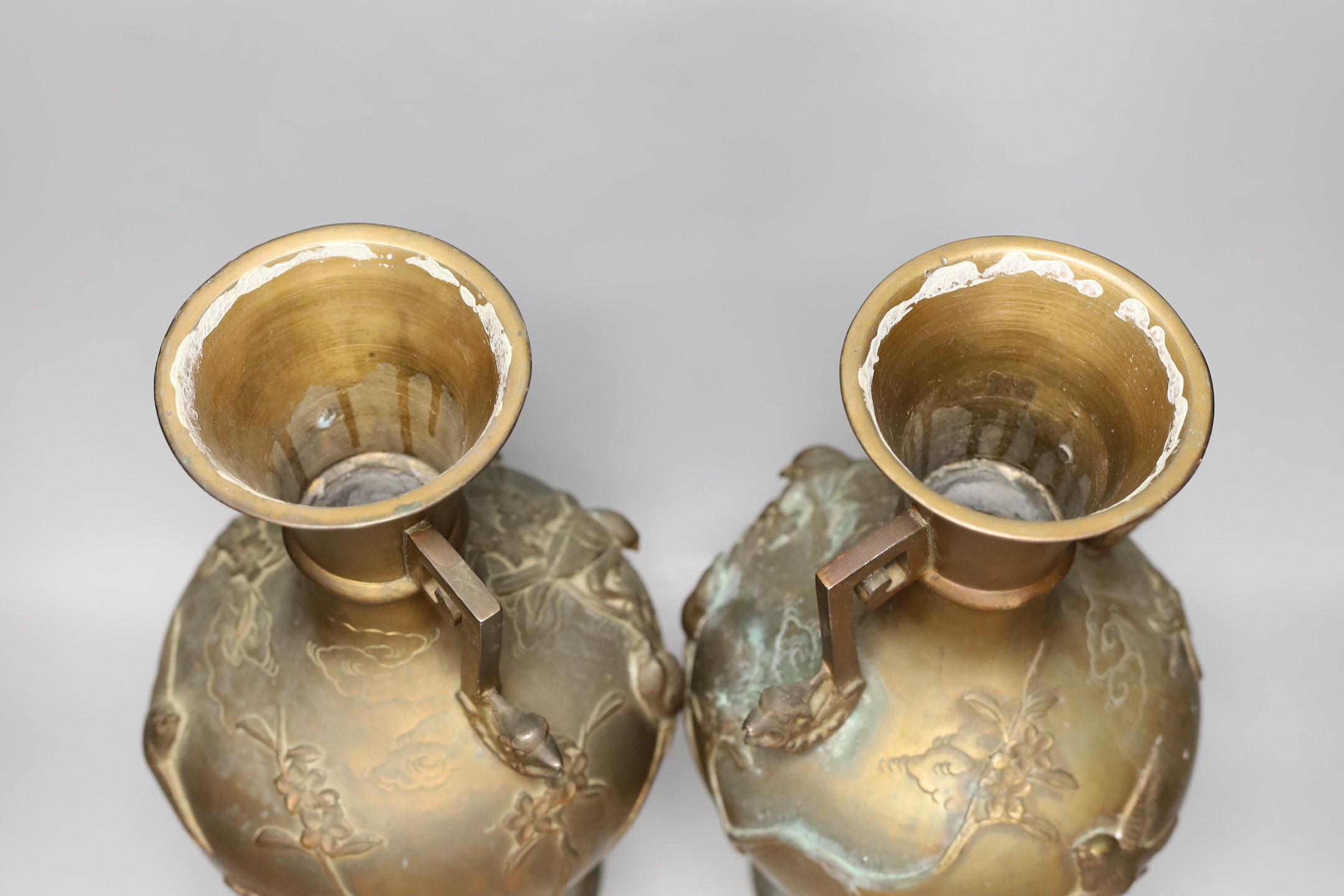 A pair of Japanese two handled bronze vases, 39.5cms high